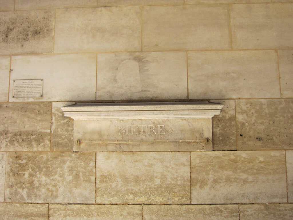 The standard metre set into a stone wall at 36 rue de Vaugirard, Paris: a marble shelf engraved METRE